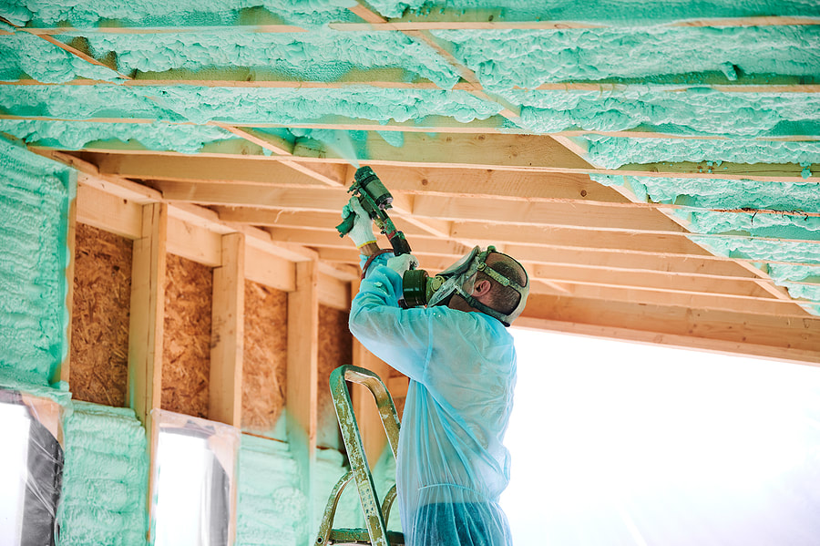 Hartford worker is spraying foam insulation in Hartford, Connecticut house.